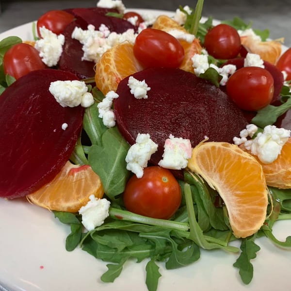 Sorella's Pizza & Pasta's beet and arugula salad with cherry tomatoes, mandarin oranges, and feta cheese.